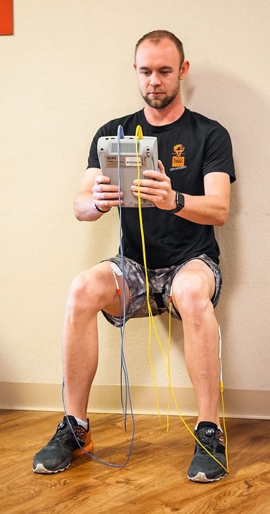 remote CRPS patient doing wall sit with the Phoenix waveform resulting in increased muscle stimulation for conditions like pain and CRPS